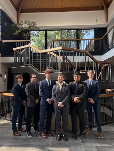 A group of team members on a staircase in business attire